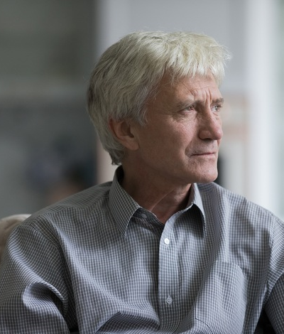 Man looking off and coping with grief and loss